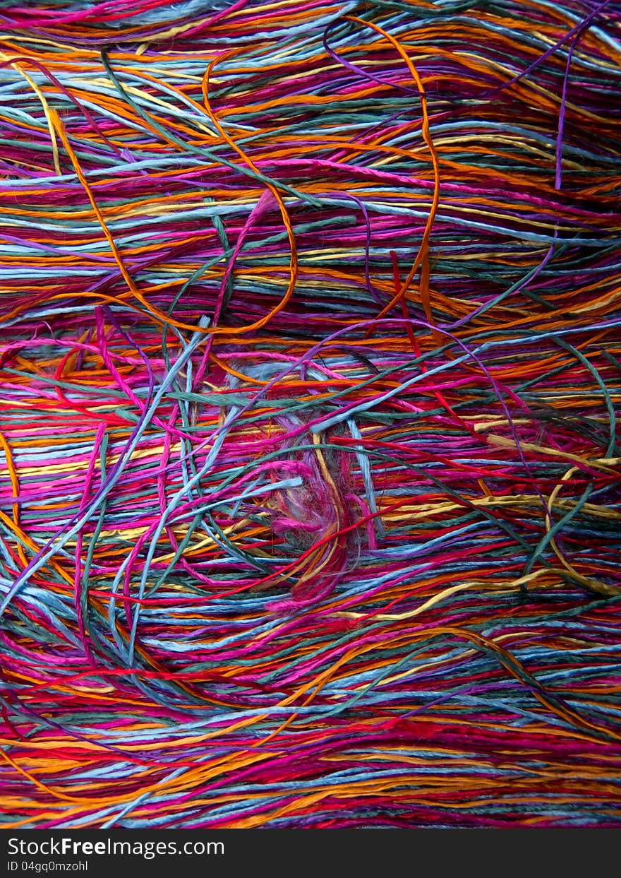 Vivid silk colored thread on a table. Vivid silk colored thread on a table