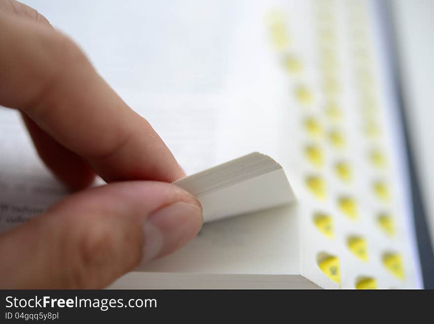 Hand flipping the bible with shallow DOF