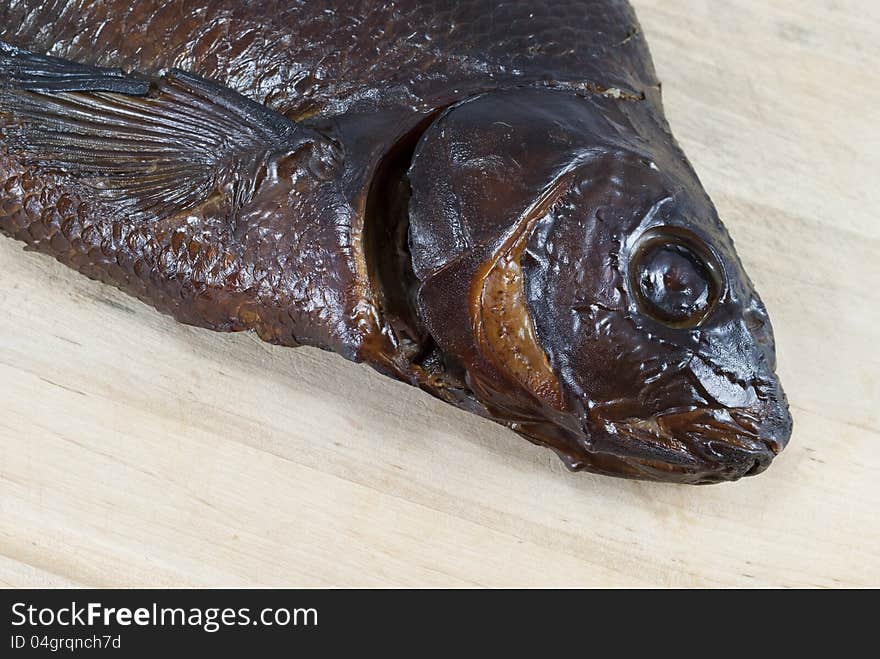 Smoked bream closeup on a wooden board. Smoked bream closeup on a wooden board