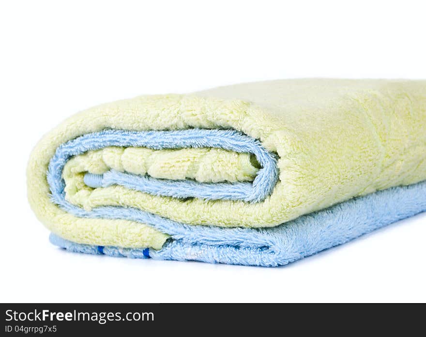 Blue towel is wrapped in green on a white background