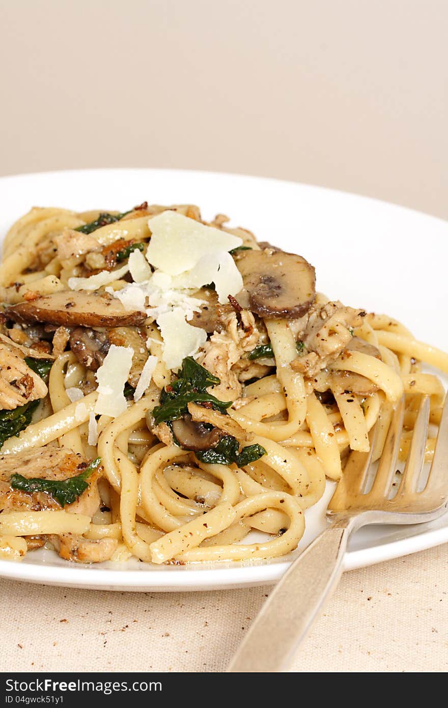 Light and tasty meal of whole wheat fettucine tossed with mushrooms chicken and spinach. Light and tasty meal of whole wheat fettucine tossed with mushrooms chicken and spinach