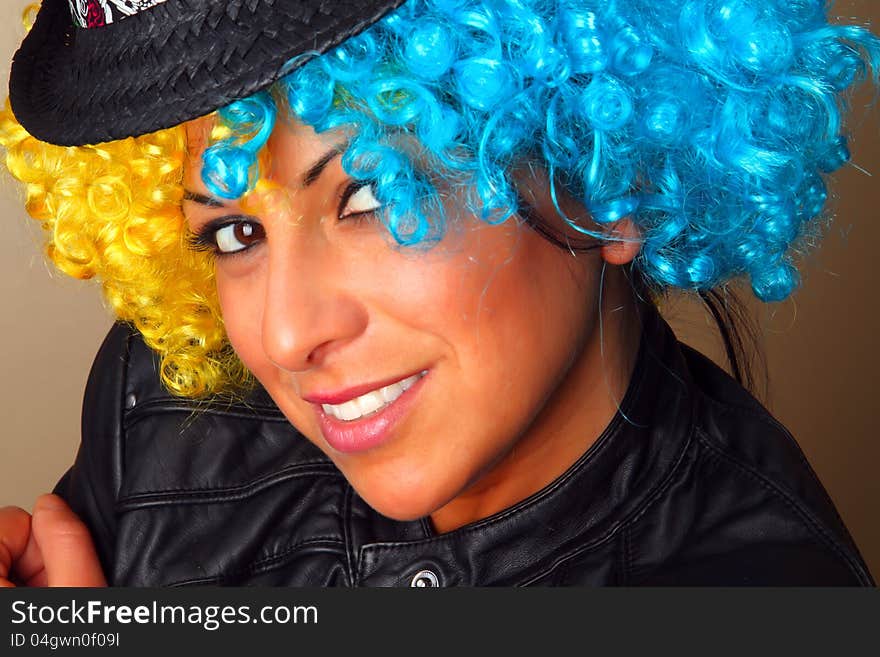 Smiling girl with a wig and a hat