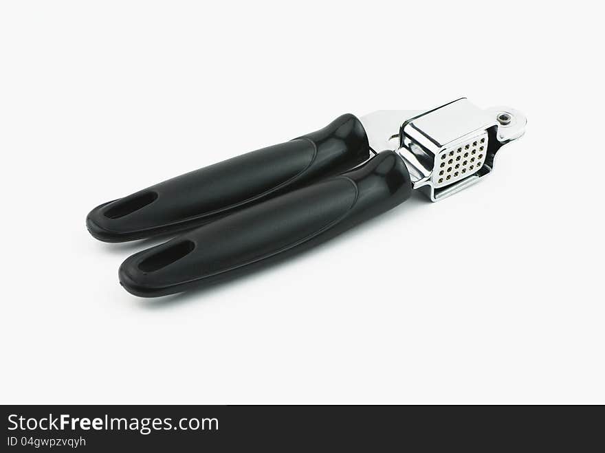 Single garlic press on white background