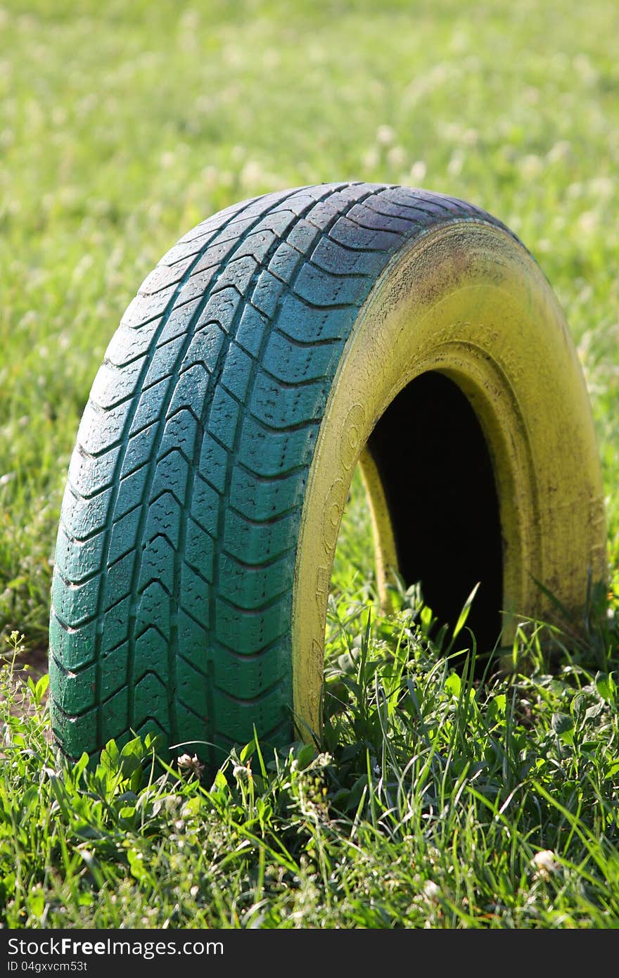 Old motor-car tire on a playground