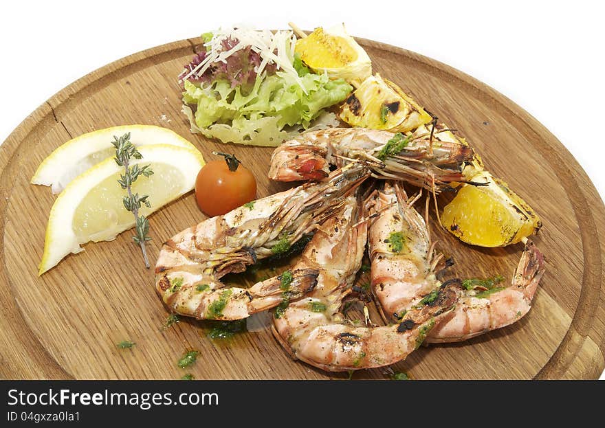 Grilled Shrimp with Orange on a wooden plate