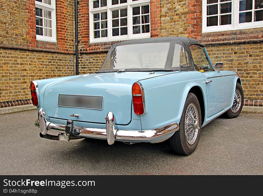 Photo of a classic car triumph tr4 in wedgwood blue with soft top hood. Photo of a classic car triumph tr4 in wedgwood blue with soft top hood.