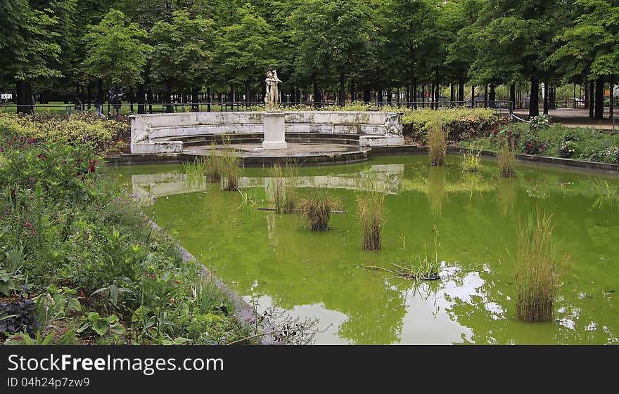 A Pond With A Statue In The Garden Of The Tuilerie