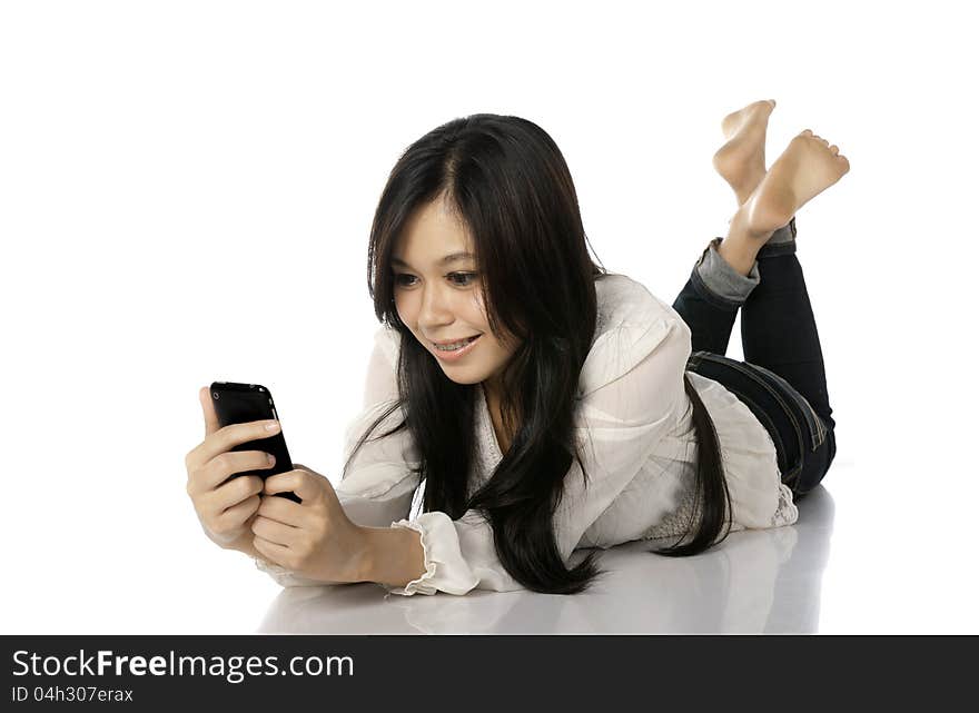 Asian woman lay on the floor while texting her friend. Asian woman lay on the floor while texting her friend