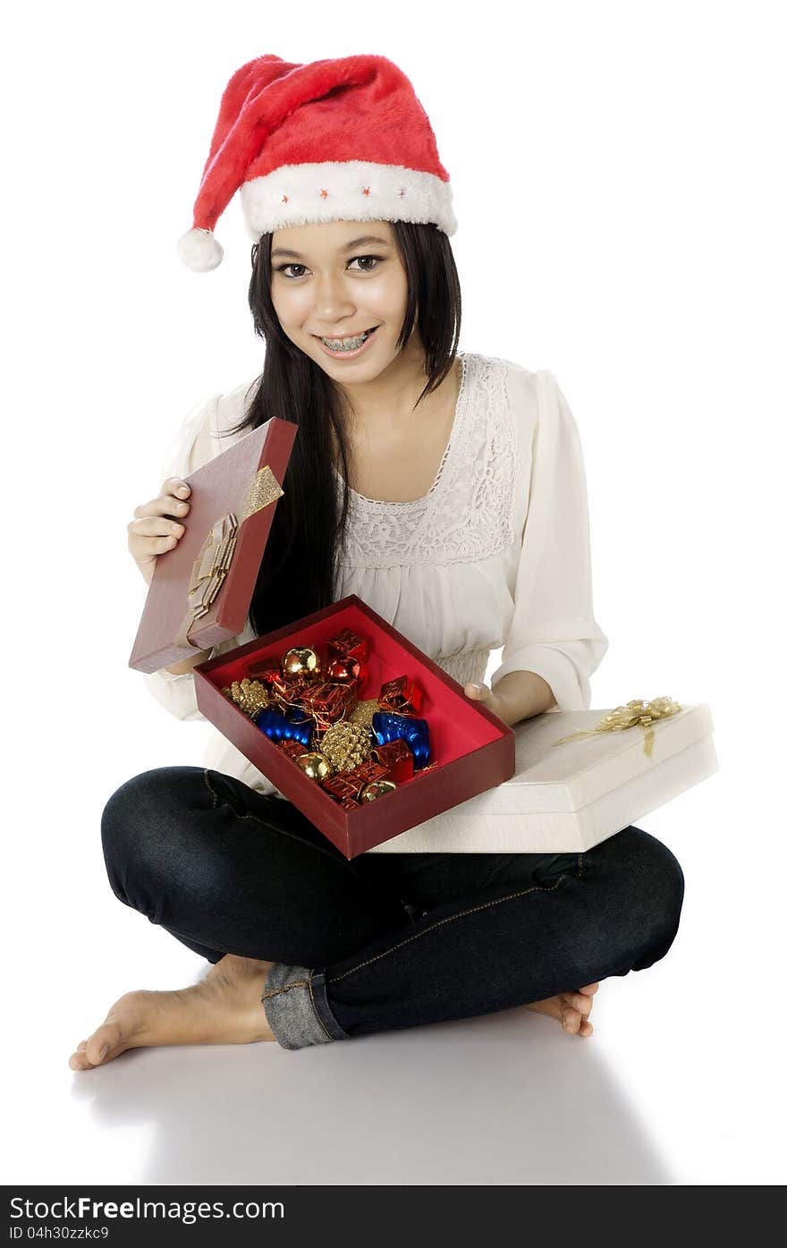 Woman wearing santa hat hold gift box isolated over white background. Woman wearing santa hat hold gift box isolated over white background