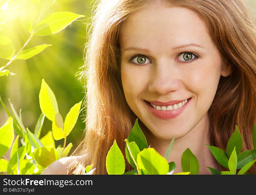 Beauty girl in nature with green leaves