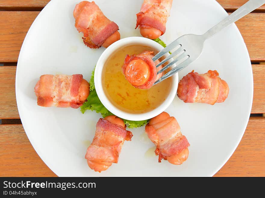 Deep fired sausage wrapped with bacon