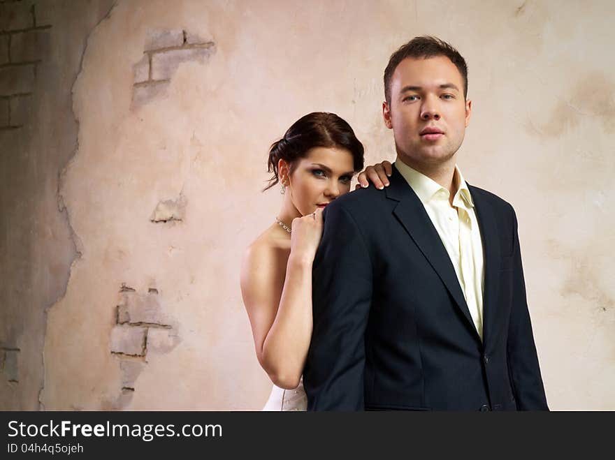 Bride and groom standing in stylish empty room. Bride and groom standing in stylish empty room