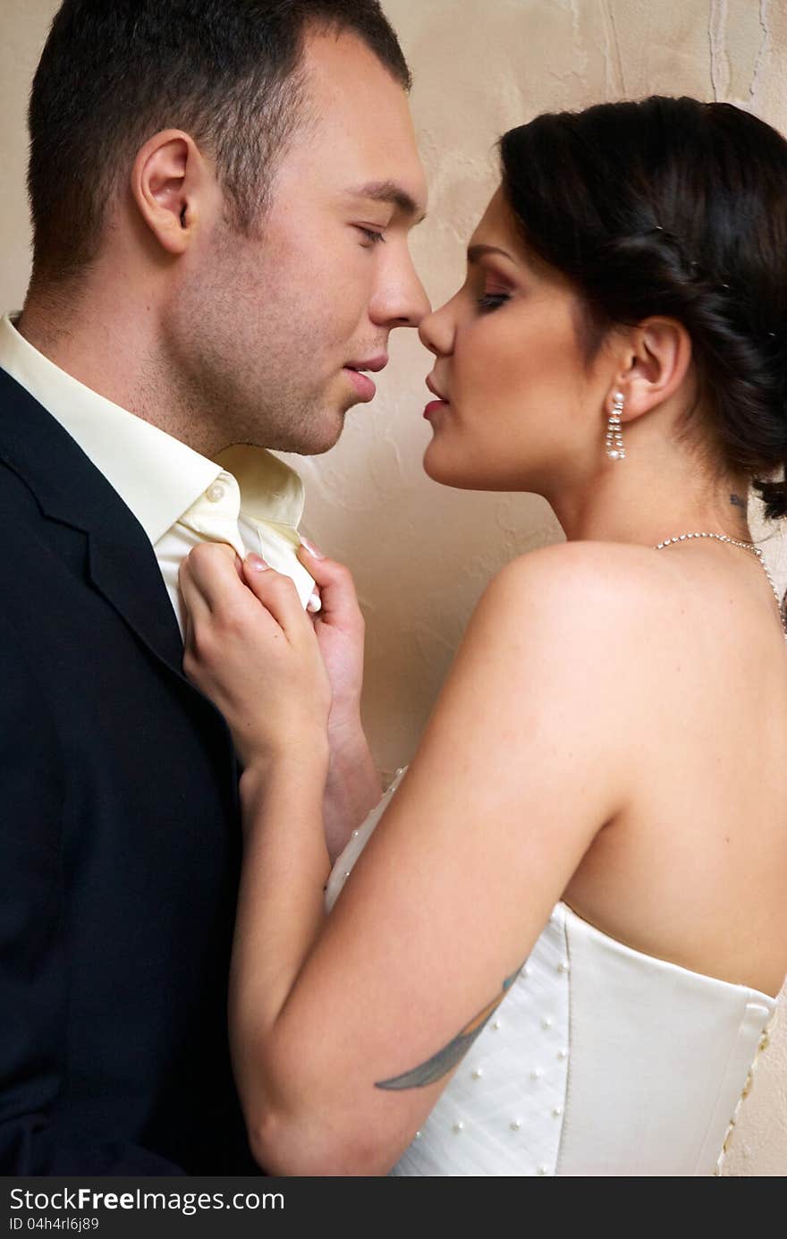 Bride and groom hugging in empty room