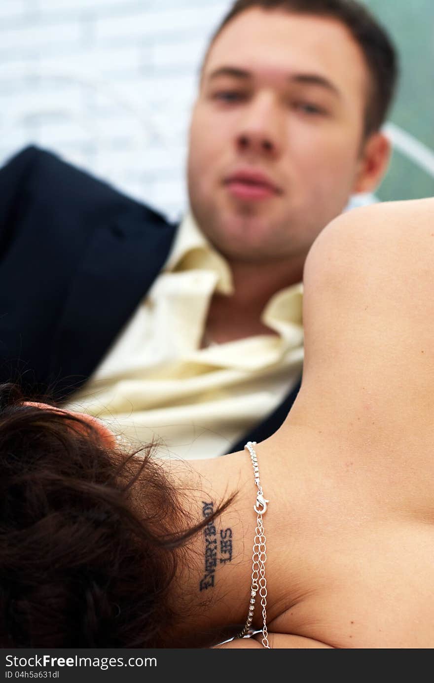 Bride and groom lying in bedroom close up