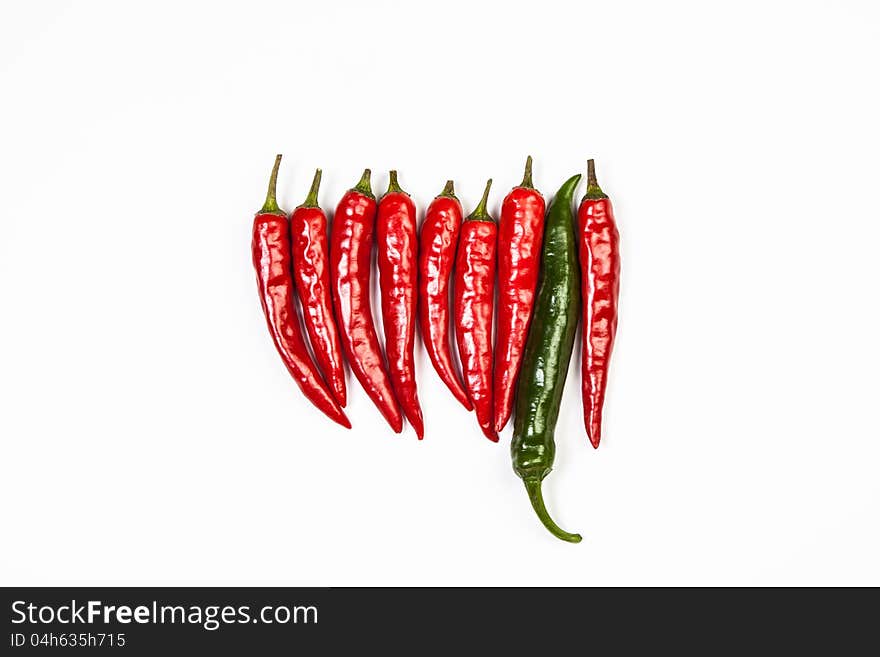 Сayenne and green pepper on white background