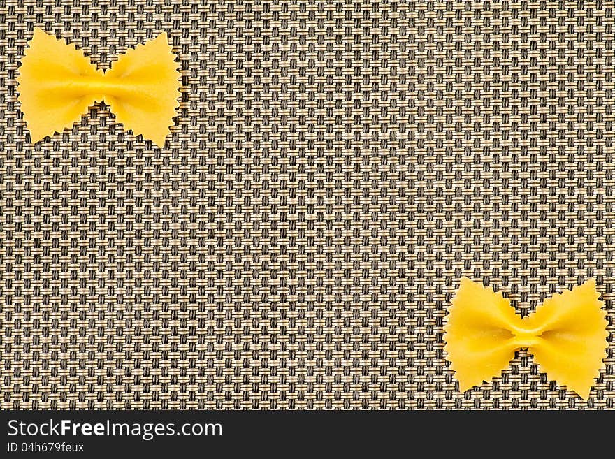 Farfalle spaghetti on beige background