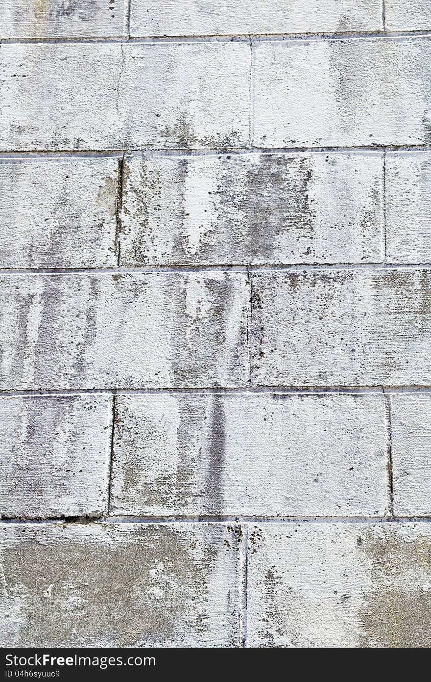 Large brick on a wall painted white. Large brick on a wall painted white.