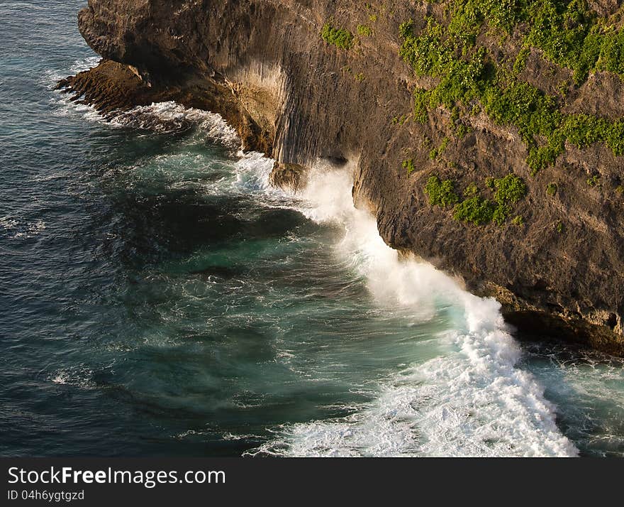 Waves crashing cliffs