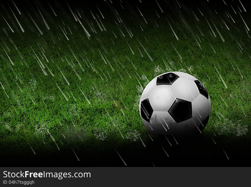 A soccer ball on grass and raining. A soccer ball on grass and raining