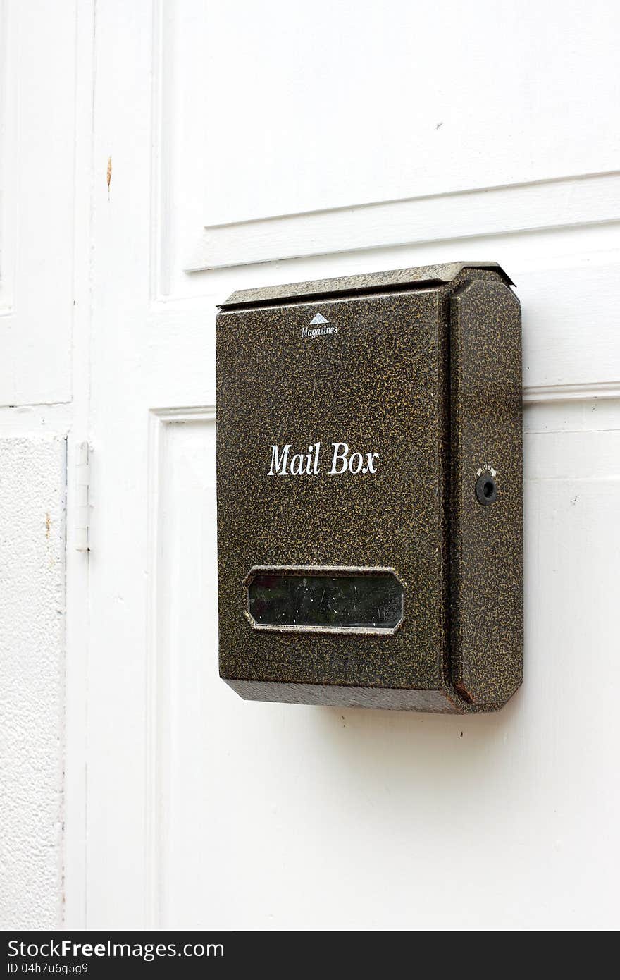 Mail box hanging on white door