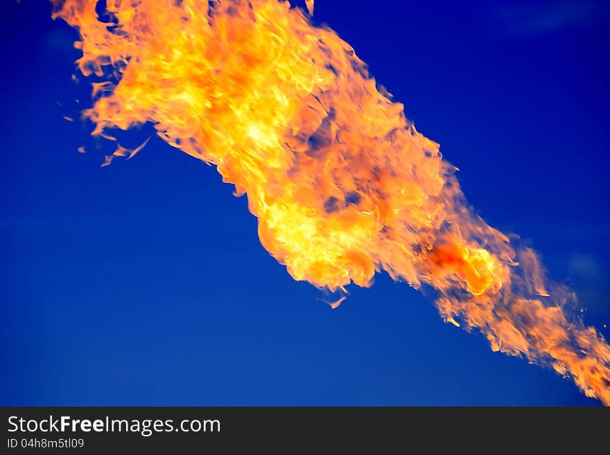 Closeup of bright fire flame on dark blue background. Closeup of bright fire flame on dark blue background