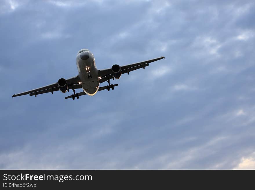 Passanger airplane landing on a cloudy evening. Passanger airplane landing on a cloudy evening