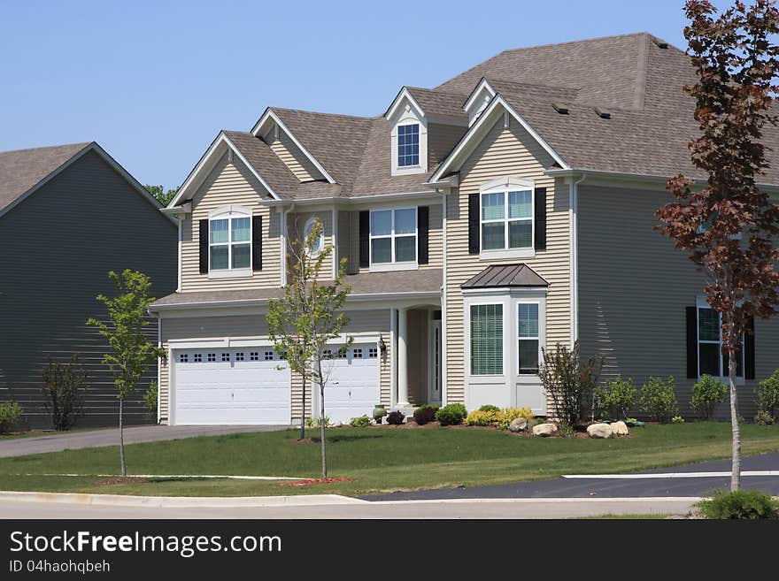 New-construction large suburban house with three-car garage. New-construction large suburban house with three-car garage