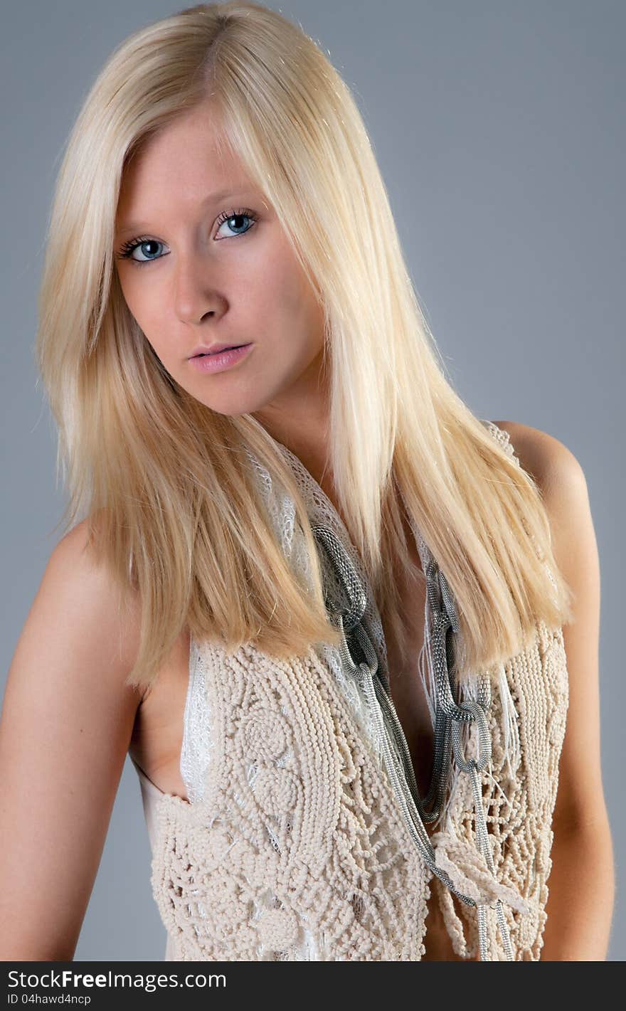 A portrait of a teenage girl wearing a macrame vest and long necklace. A portrait of a teenage girl wearing a macrame vest and long necklace