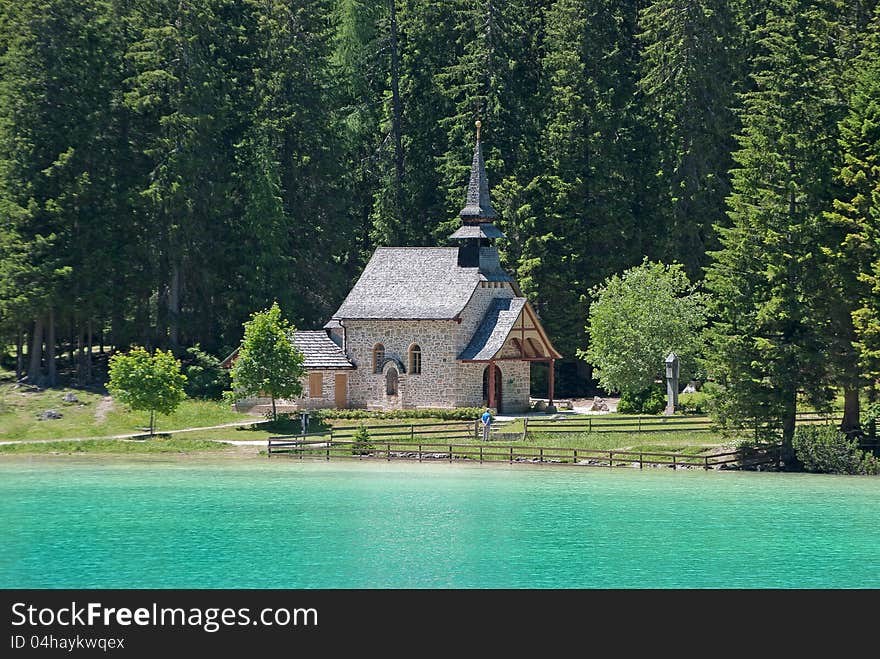 Romantic church in dolomite area with big mountains trees on the background. Romantic church in dolomite area with big mountains trees on the background