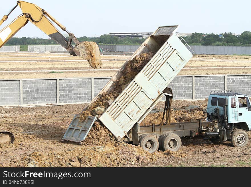 Backhoe and dump truck