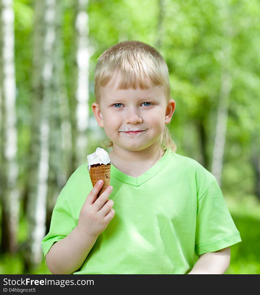 Child eating a tasty ice cream outdoors