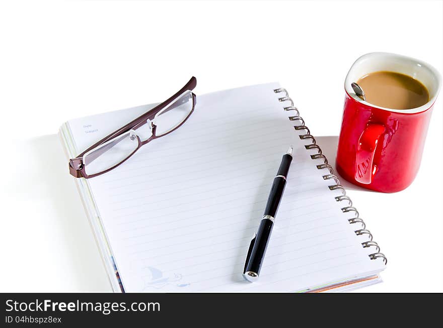 Notebook, pen, coffee red cup on the isolated background