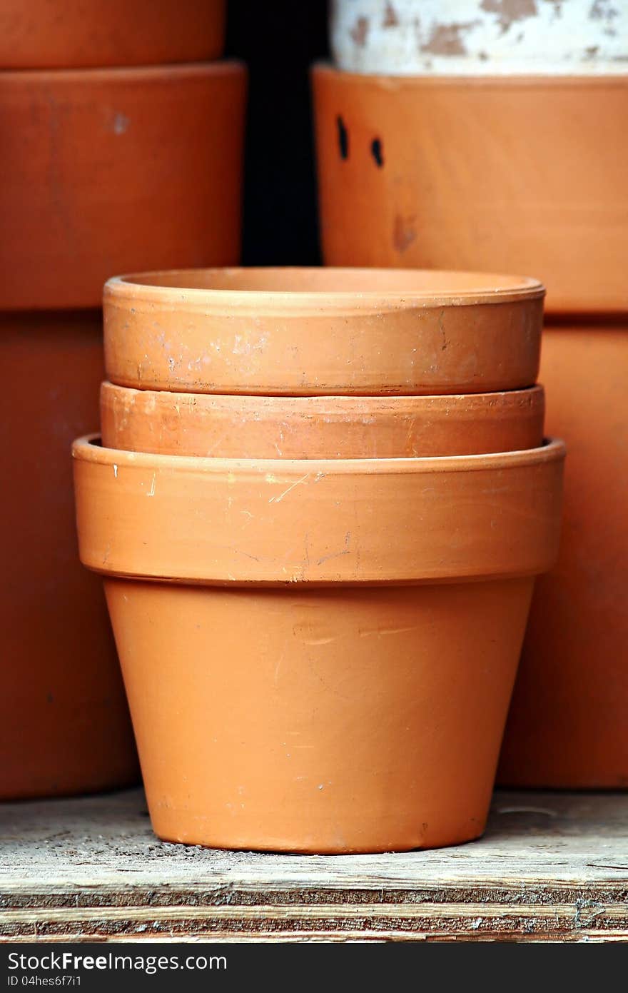 Three terra cotta pots, stacked. Three terra cotta pots, stacked.