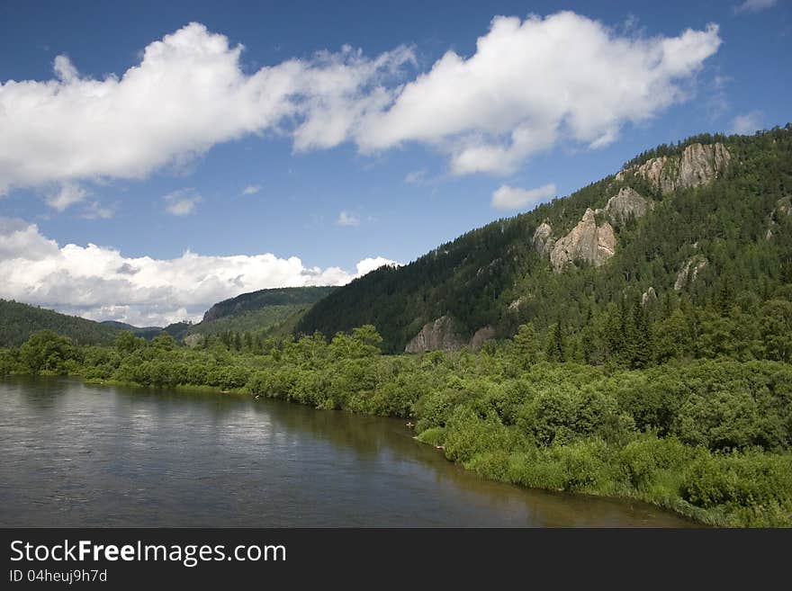 A river landscape with clouds.