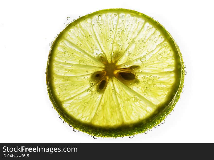 Lime slice floating in soda water