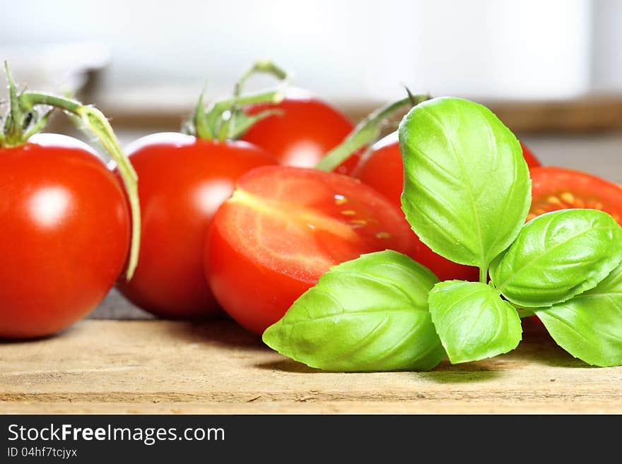 Basil with tomatoes in the background