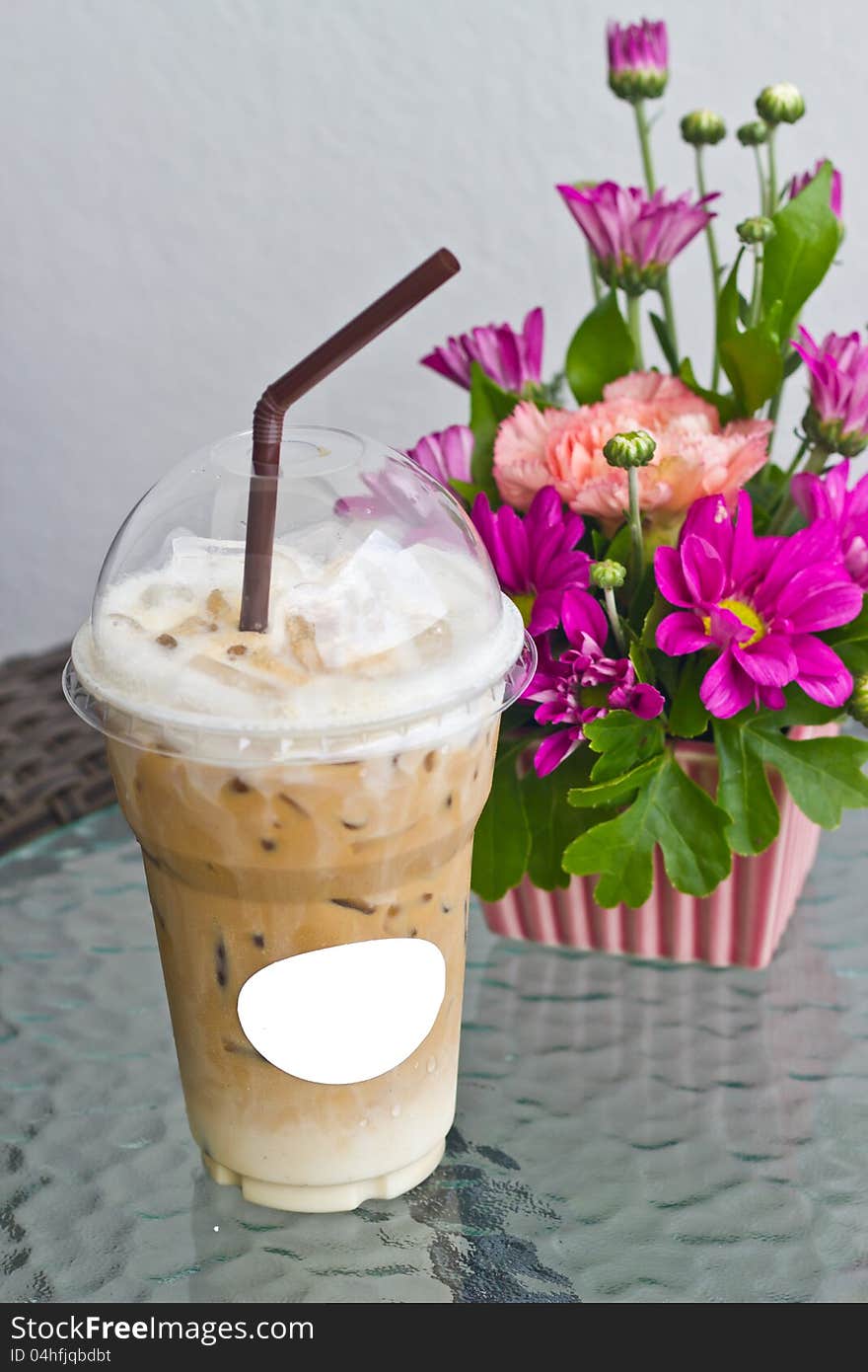 Ice coffee and vase of flower