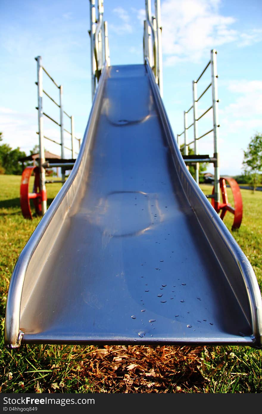 Old metal slide at a playground. Old metal slide at a playground.