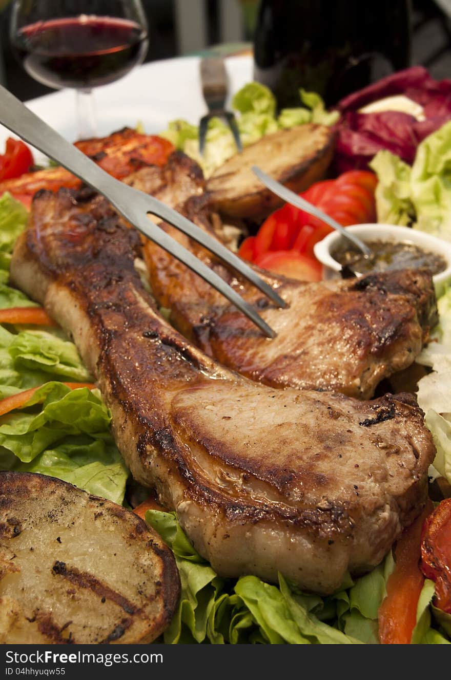 Pork chop on a bed of salad