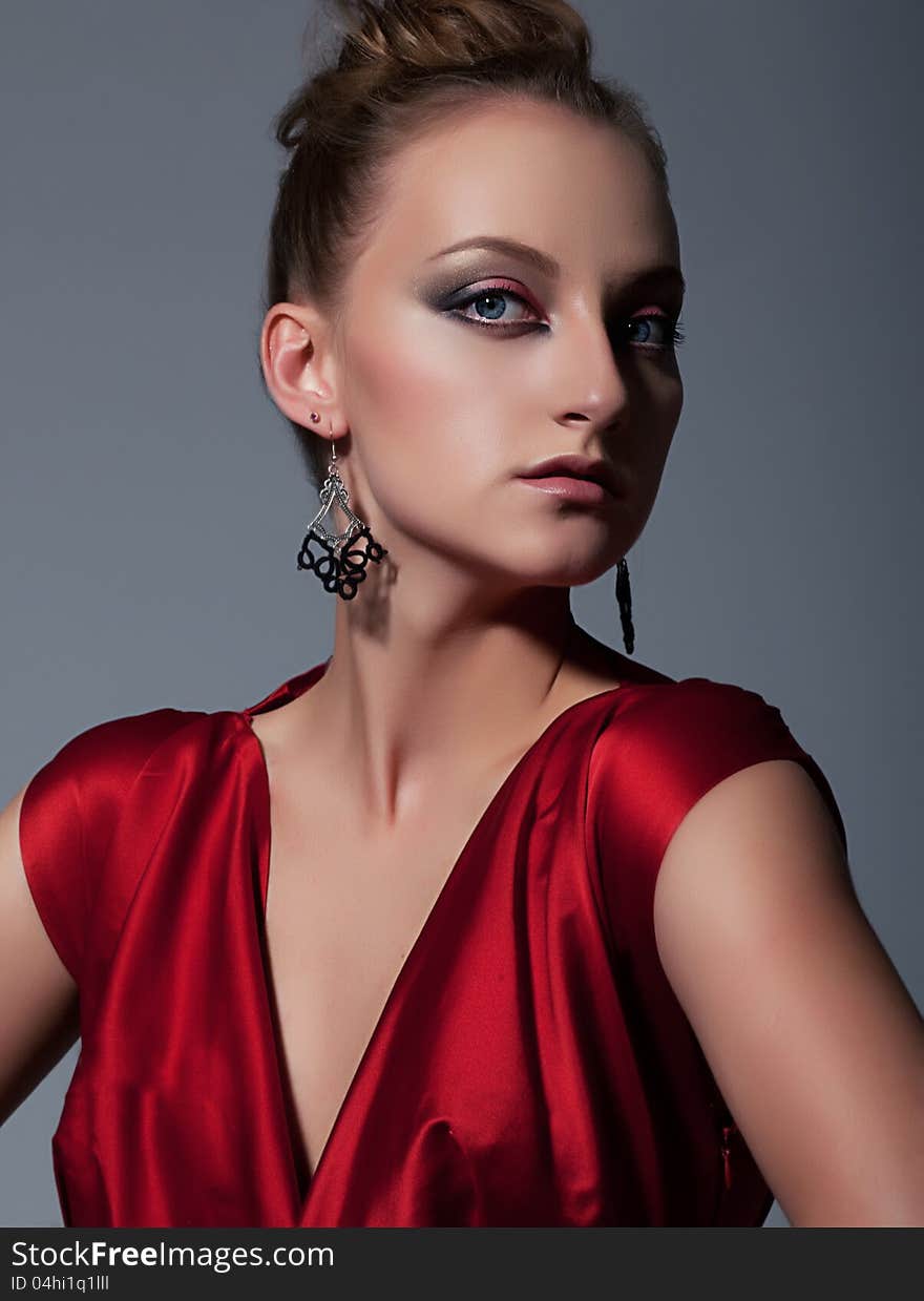 Portrait of attractive woman in red dress. Studio shot. Portrait of attractive woman in red dress. Studio shot