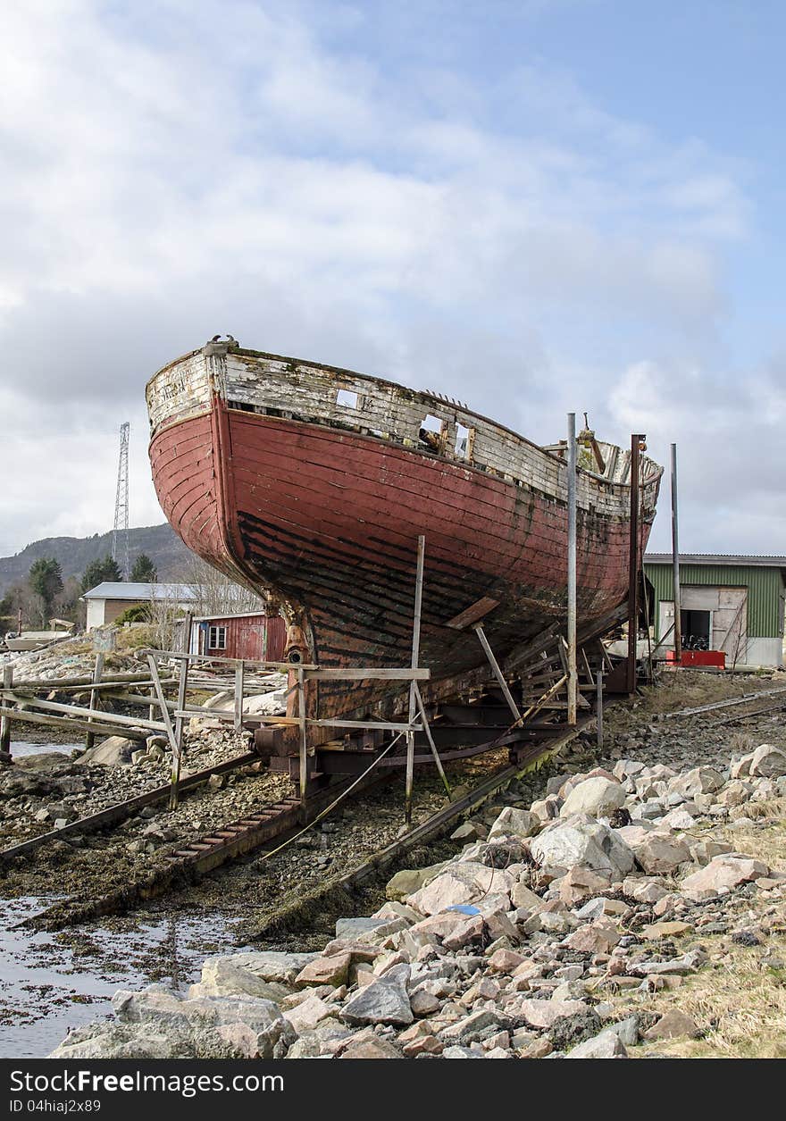 Old rusty wood ship on shore