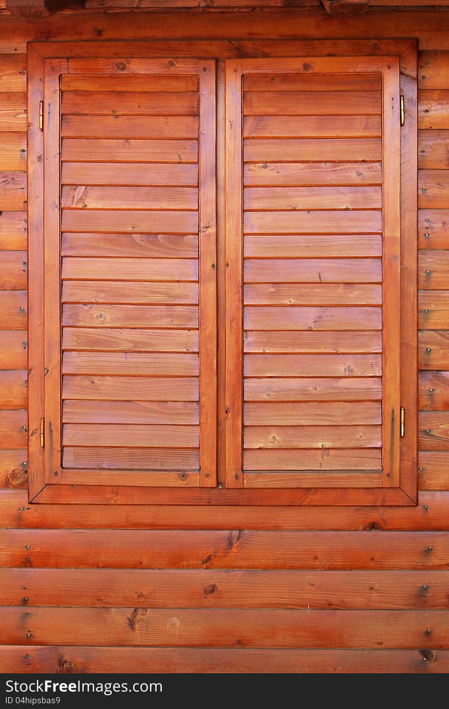 Closed wooden window on wood wall