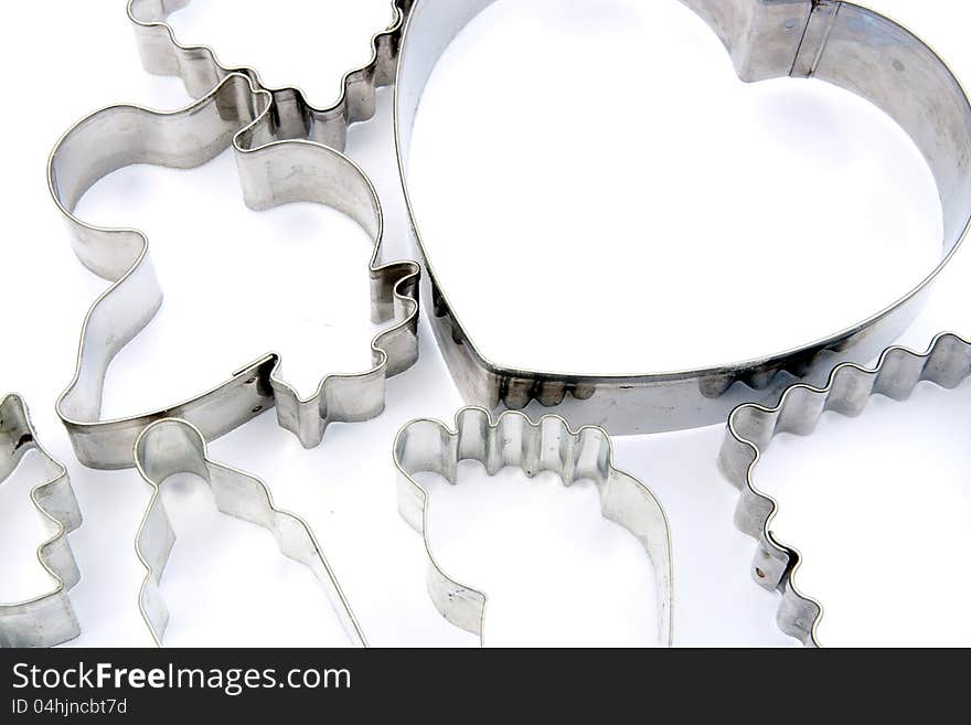 Many metal cookie cutters on white. Many metal cookie cutters on white