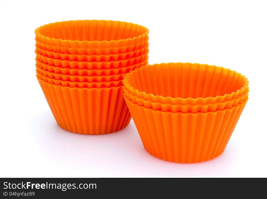 Orange silicone cupcake liners on white. Orange silicone cupcake liners on white