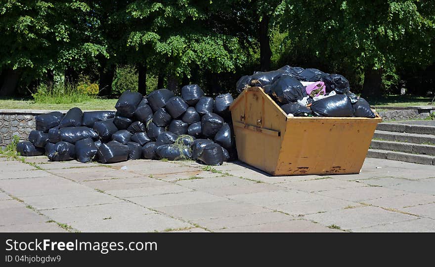 Container with garbage on the street in the city