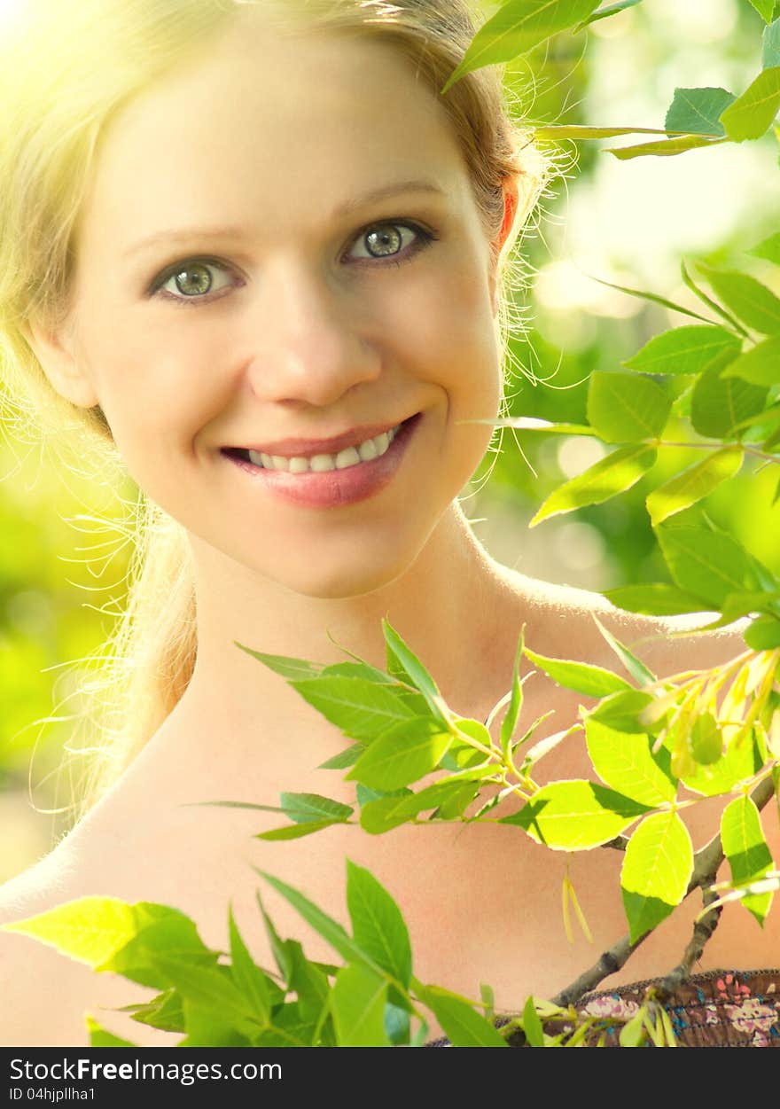 Face of beauty girl in nature with green leaves