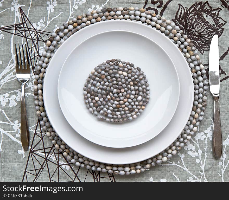 Table place setting with beaded mats made by African craftsmen