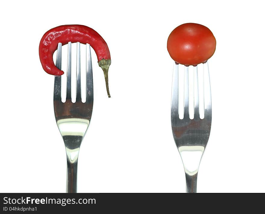 Hot peppers and cherry tomatoes hooked fork. Hot peppers and cherry tomatoes hooked fork