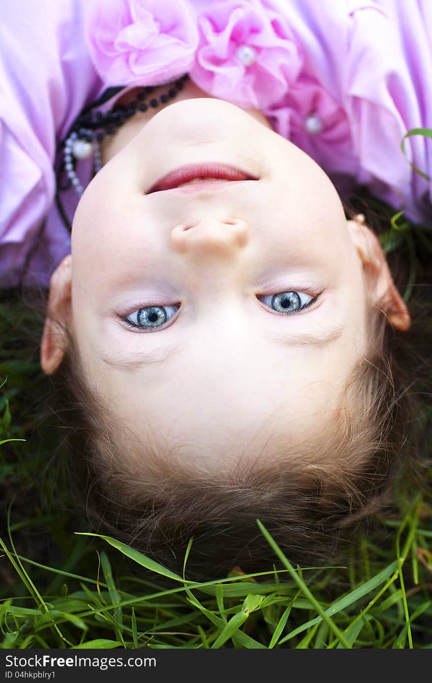 Little cute girl lying on herb, close up. Little cute girl lying on herb, close up