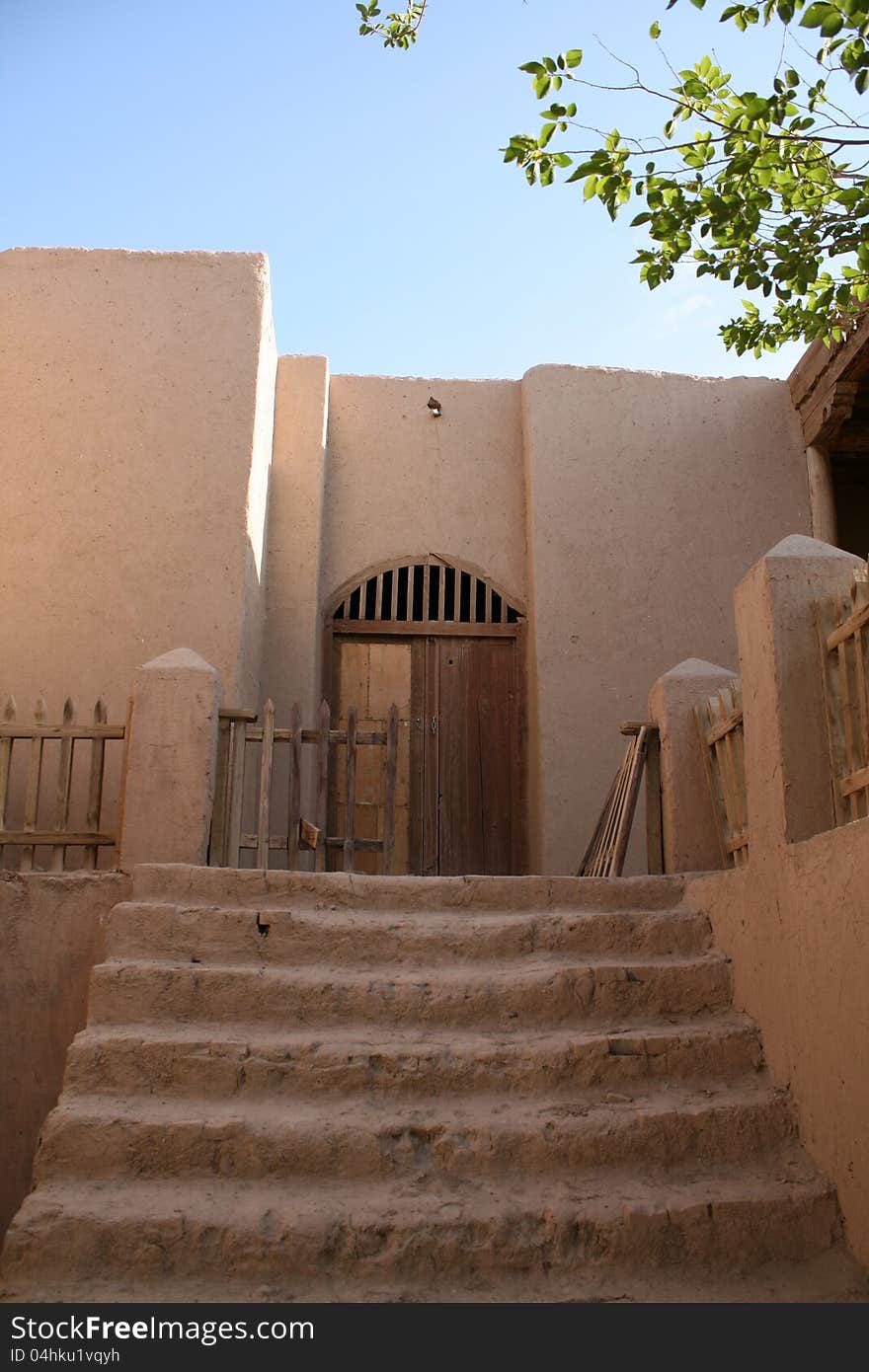 Exterior earth wall of STRAW BALE HOUSE AND EARTHEN HOUSE in Chinese ancient theme village in Dunhuang,Gansu province, China. located in rural area near Gobi desert, part of ancient silk road. Exterior earth wall of STRAW BALE HOUSE AND EARTHEN HOUSE in Chinese ancient theme village in Dunhuang,Gansu province, China. located in rural area near Gobi desert, part of ancient silk road.